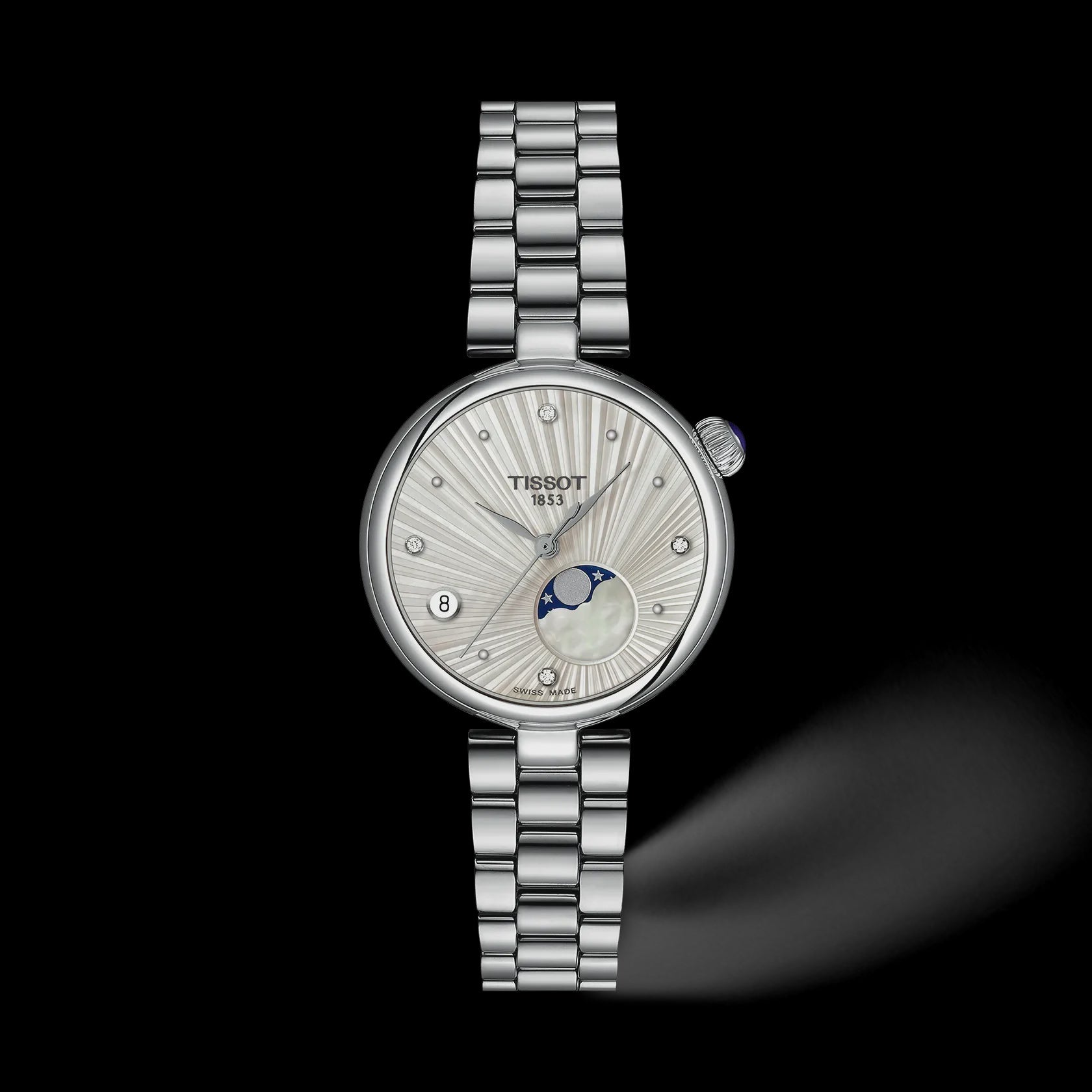 A Tissot Innopolis women's watch featuring a silver stainless steel link bracelet, a round silver case, and a white sunburst dial with a moonphase indicator, set against a solid black background.