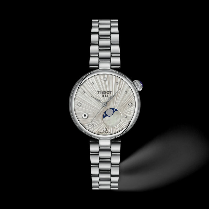 A Tissot Innopolis women's watch featuring a silver stainless steel link bracelet, a round silver case, and a white sunburst dial with a moonphase indicator, set against a solid black background.