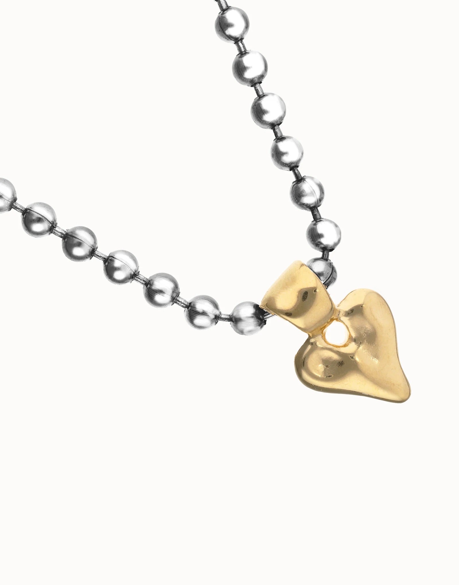 UNOde50 silver plated beaded necklace with gold plated heart pendant, front view.