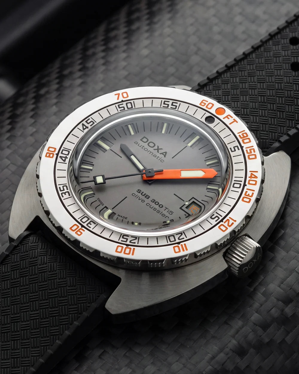 Close-up of the DOXA SUB 300 Ti5 Clive Cussler automatic watch, showing its grey dial, orange accents and dive bezel.