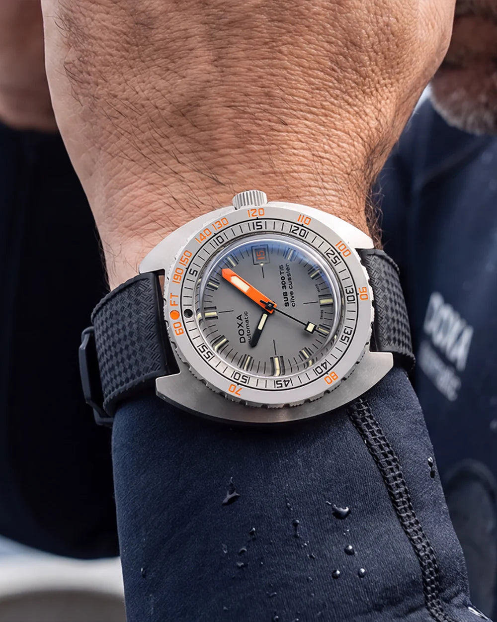 DOXA SUB 300 Ti5 Clive Cussler automatic dive watch worn on the wrist with a black rubber strap.