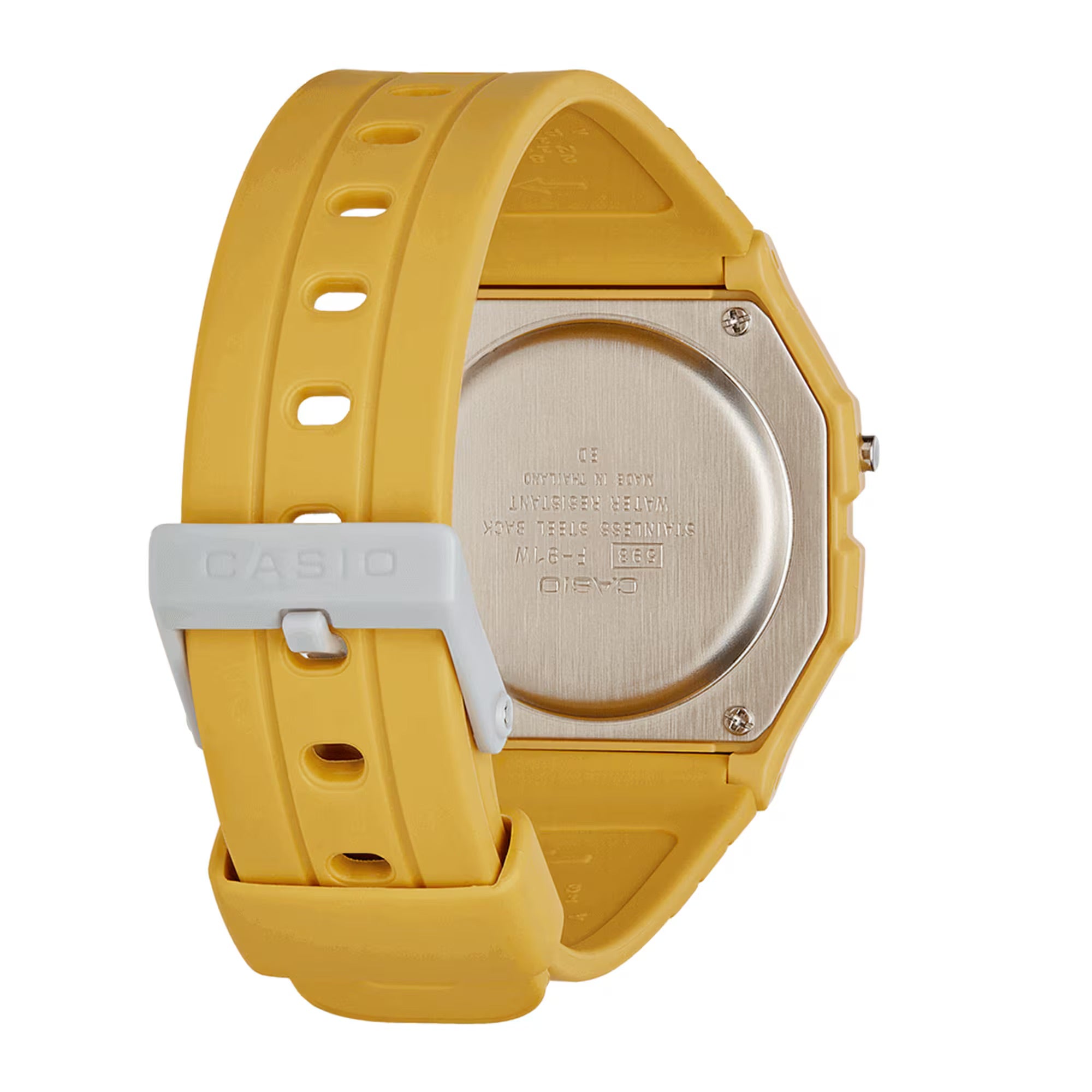 The back view of a Casio watch with a bright yellow silicone strap, a brushed silver-tone metal case back, and a white plastic buckle.