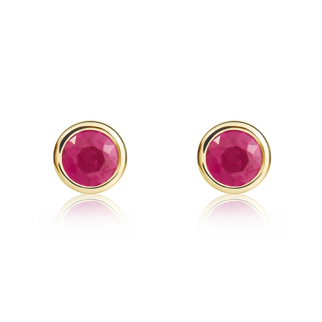 Pair of 9ct yellow gold ruby stud earrings featuring round pinkish-red rubies in polished rubover settings.