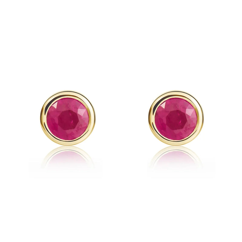 Pair of 9ct yellow gold ruby stud earrings featuring round pinkish-red rubies in polished rubover settings.