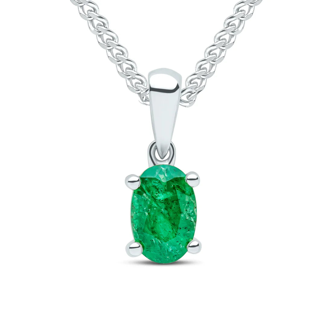 9ct White Gold pendant featuring an oval Emerald gemstone in a classic four claw setting, suspended from a White Gold chain.