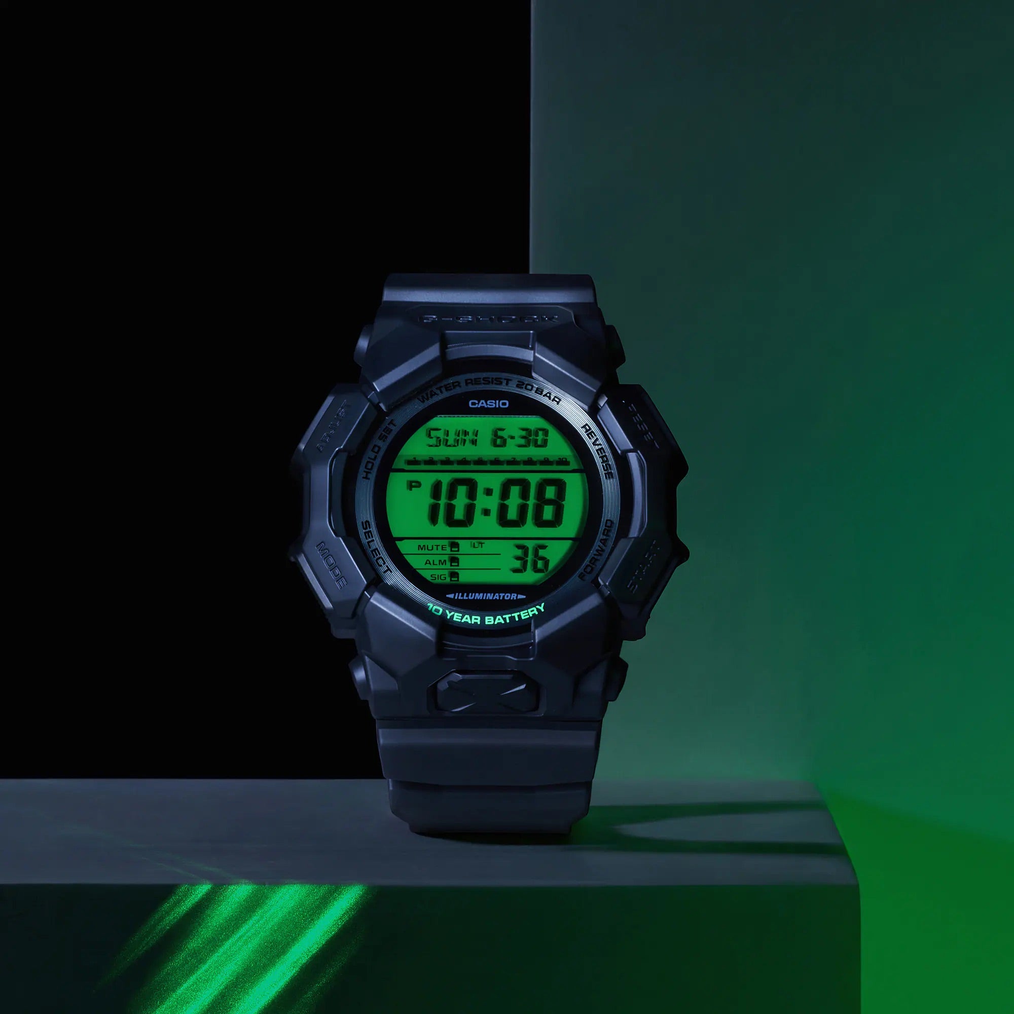 Digital watch with green display on a black and green gradient background