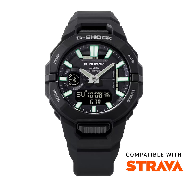 Black Casio G-SHOCK ana-digi watch with green luminous hour markers, silver hands, digital display and black resin strap, featuring Strava compatibility.