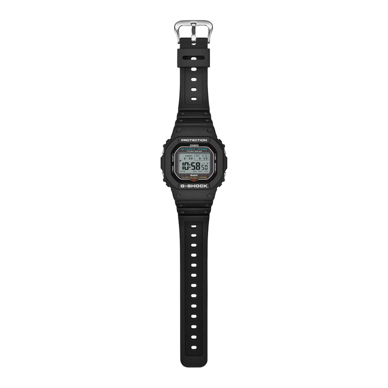 A black Casio G-Shock digital watch with a black strap and silver buckle, shown vertically against a plain white background.