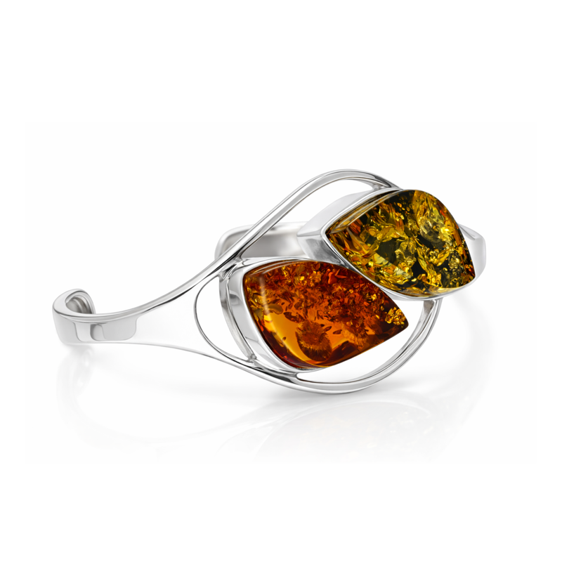Sterling silver handmade bangle featuring orange and green Baltic amber stones in a flowing open design on a white background.