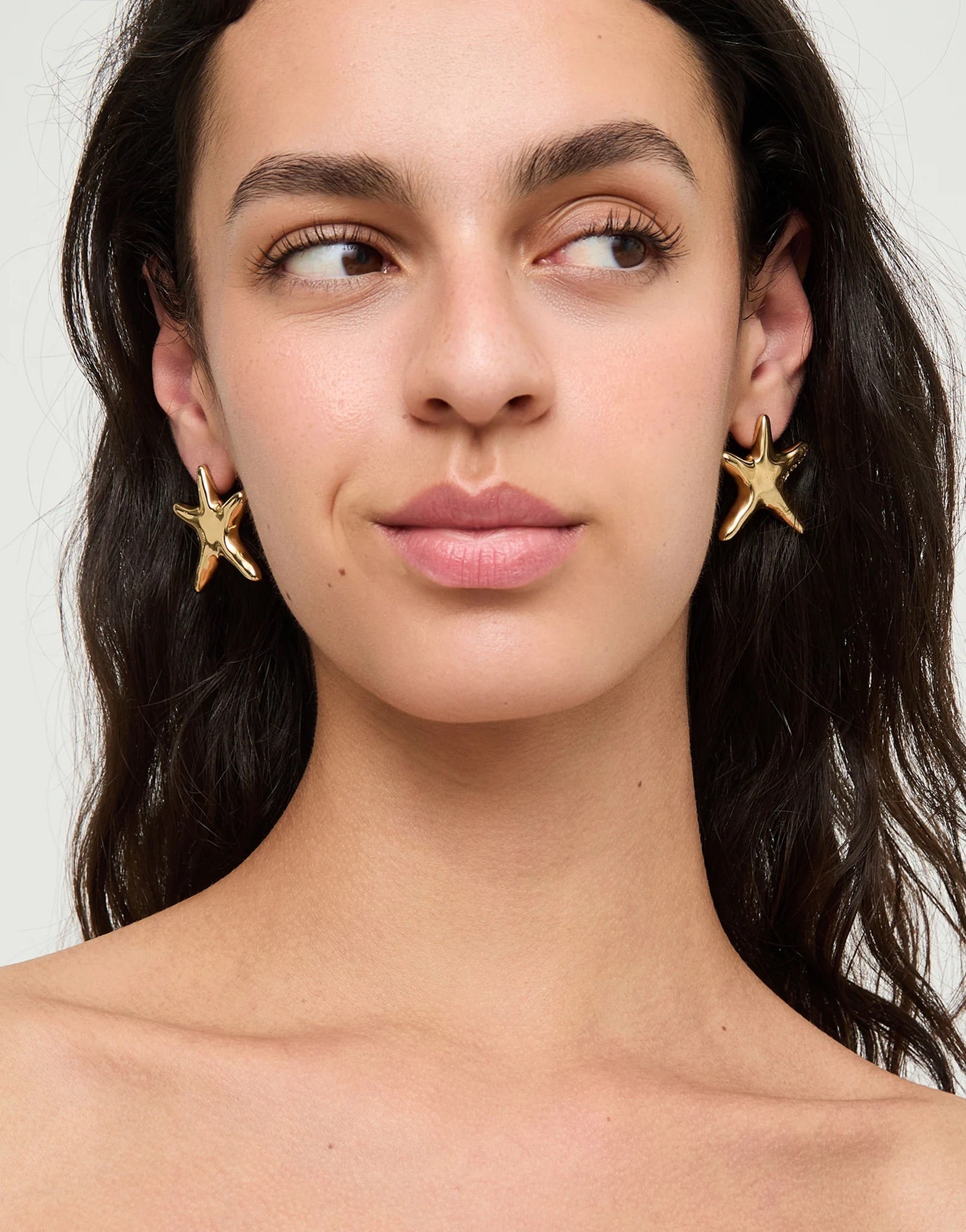 UNOde50 gold plated starfish stud earrings with polished organic starfish design, front view.