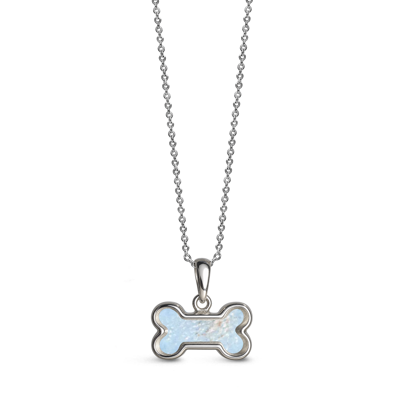 Sterling silver dog bone-shaped ashes keepsake pendant necklace featuring a baby blue glitter memorial setting with incorporated ashes and a polished silver border.