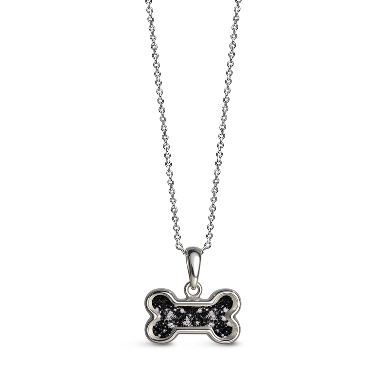 Sterling silver dog bone-shaped ashes keepsake pendant necklace featuring a black glitter memorial setting with incorporated ashes and a polished silver border.