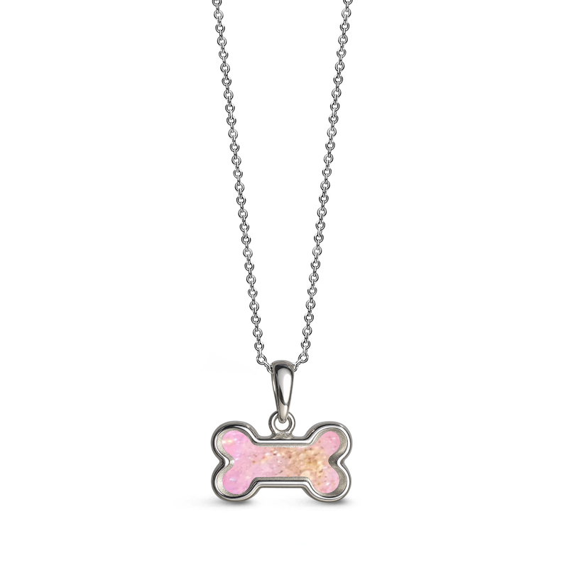 Sterling silver dog bone-shaped ashes keepsake pendant necklace featuring a fuchia pink glitter memorial setting with incorporated ashes and a polished silver border.
