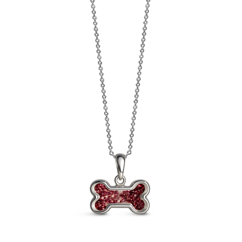 Sterling silver dog bone-shaped ashes keepsake pendant necklace featuring a ruby glitter memorial setting with incorporated ashes and a polished silver border.