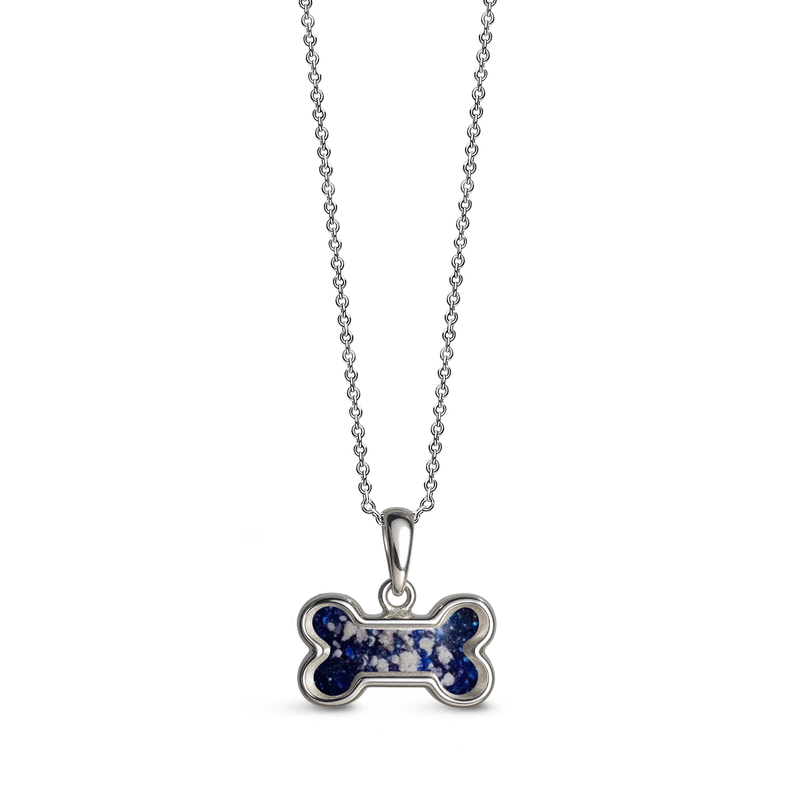 Sterling silver dog bone-shaped ashes keepsake pendant necklace featuring a sapphire glitter memorial setting with incorporated ashes and a polished silver border.