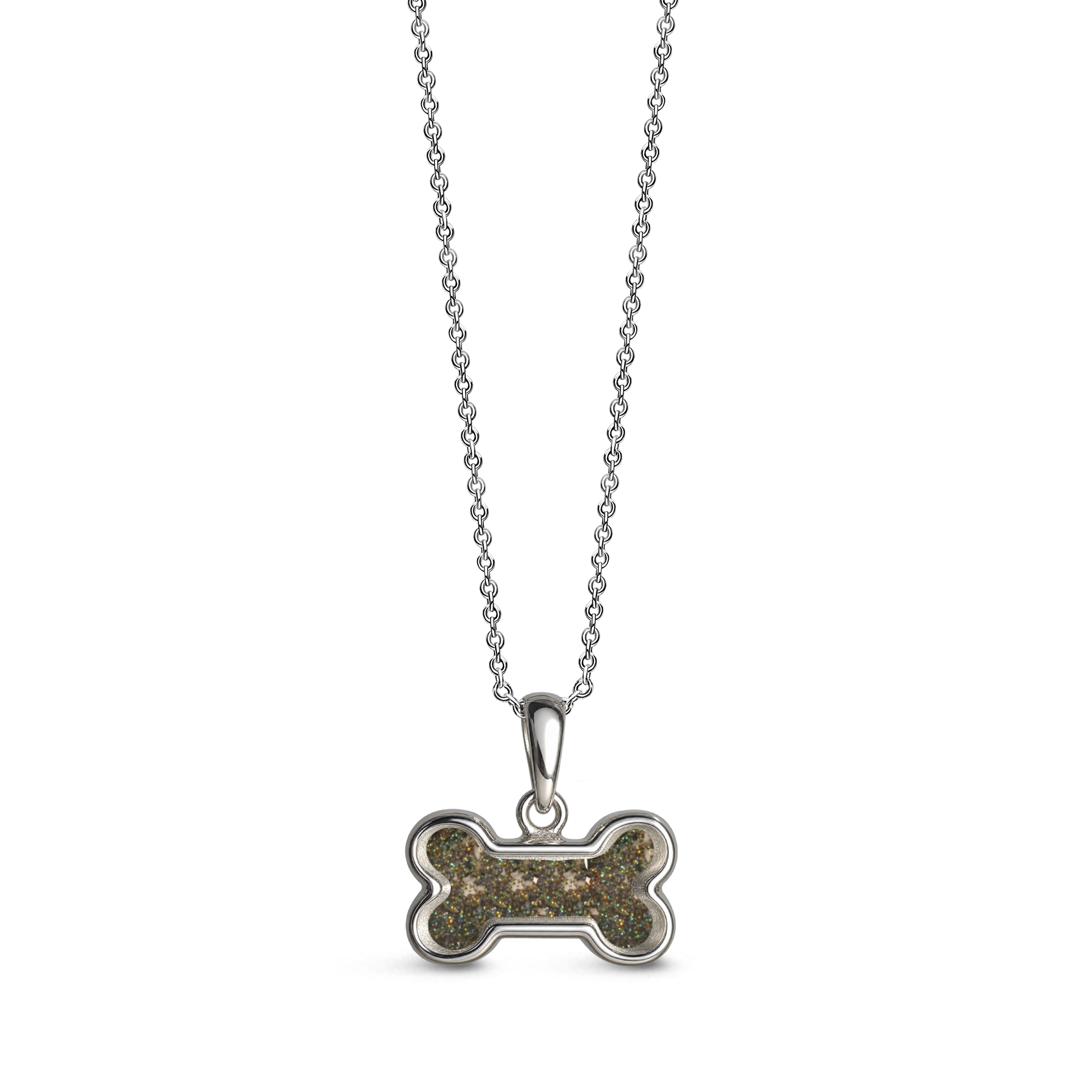 Sterling silver dog bone-shaped ashes keepsake pendant necklace featuring a dark glitter memorial setting with incorporated ashes and a polished silver border.