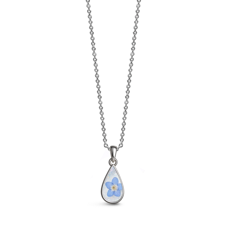 Sterling silver teardrop-shaped ashes keepsake pendant necklace featuring a blue forget-me-not flower on a white glitter memorial setting with incorporated ashes and a polished silver border.