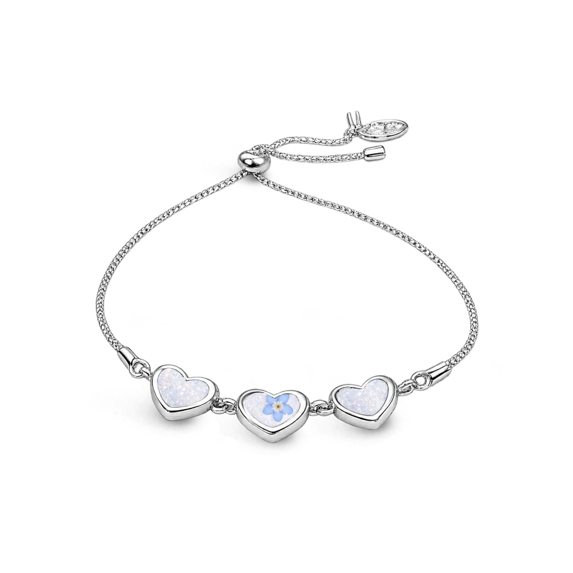 Sterling silver three-heart ashes keepsake bracelet featuring shimmering white memorial settings, a blue forget-me-not flower in the centre heart and an adjustable slider fastening.